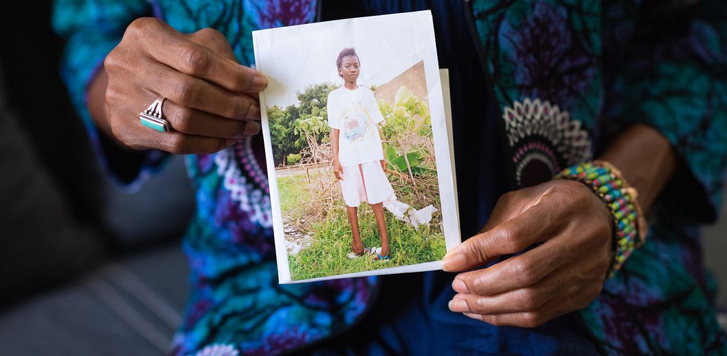 Image of women holding a photo of her younger self Cover Image