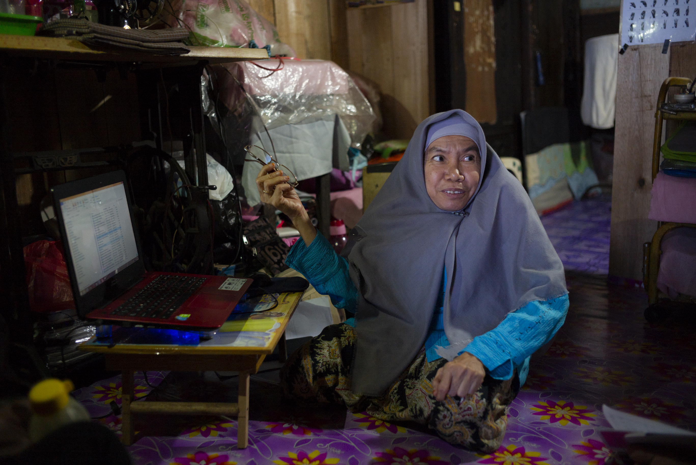 An older woman is sat working at a laptop Cover Image