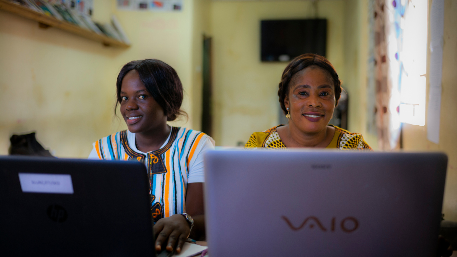 Two women working on computers Cover Image