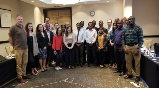 Group of participants standing and smiling. Cover Image