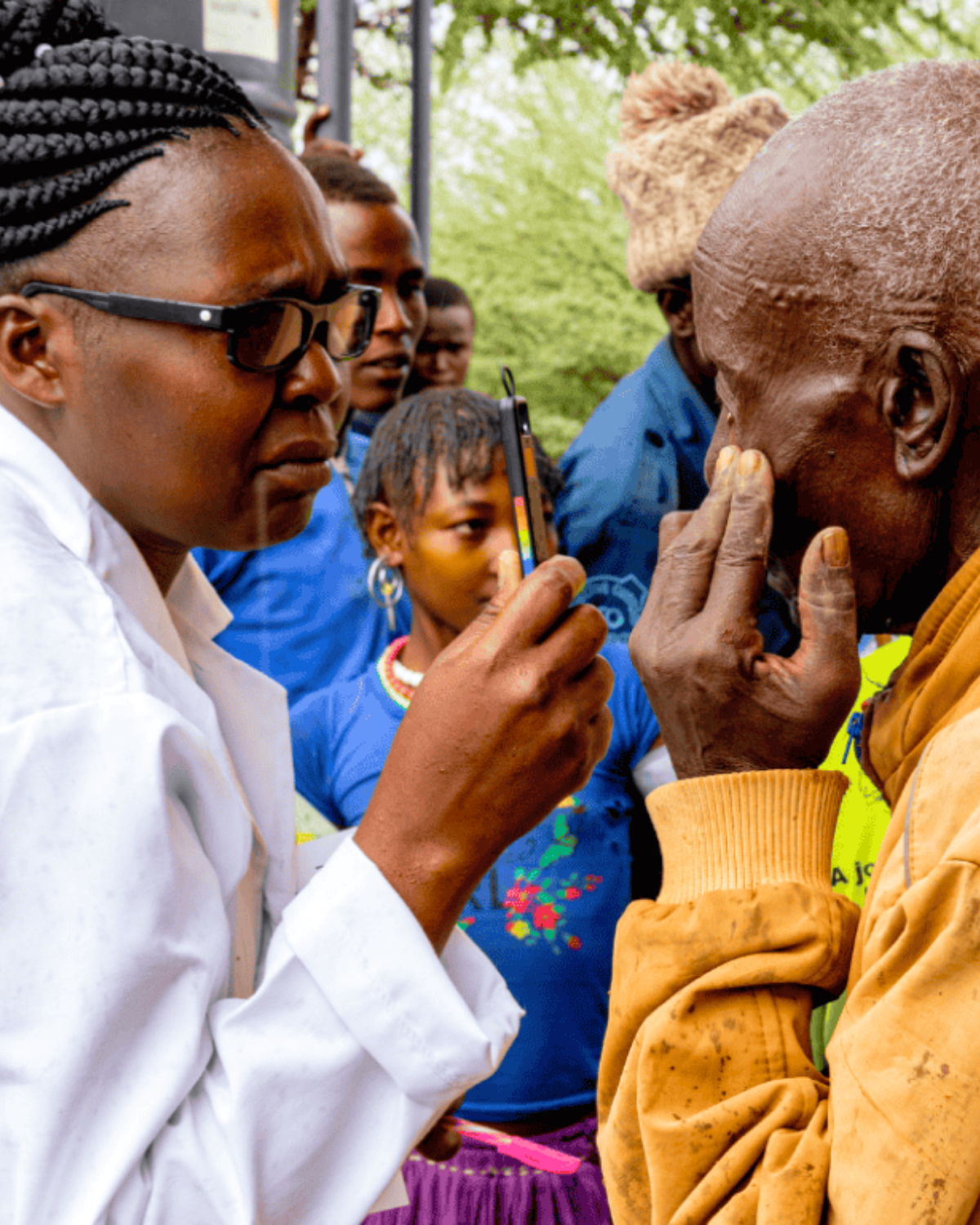 a person in a lab coat is talking to a person while testing their vision Cover Image
