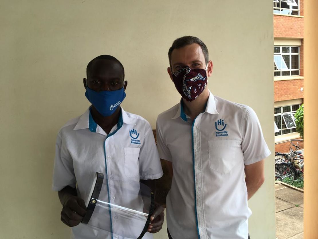 Disan, left, HI 3D Technician, with a finished 3D printed face shield, Arua Uganda Cover Image