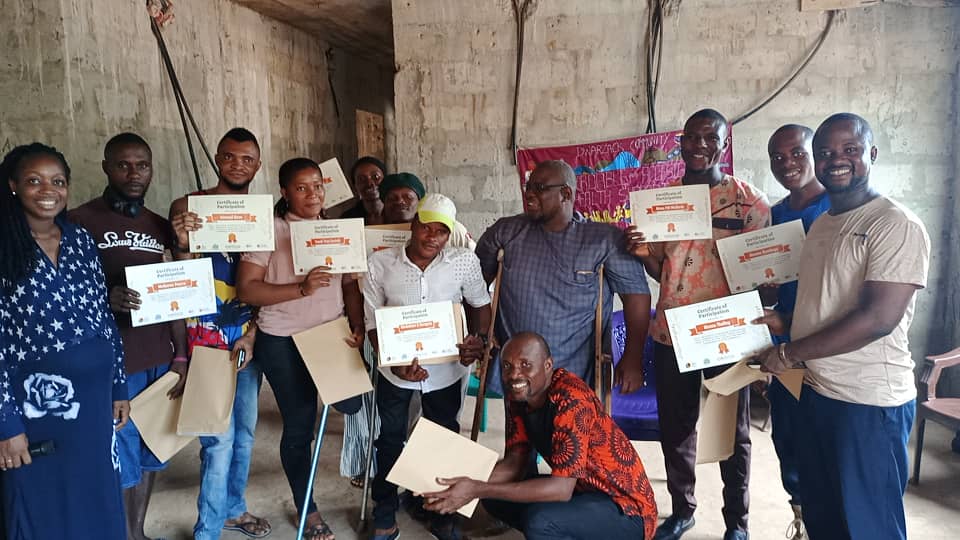 A group of people holding certificates and smiling Cover Image