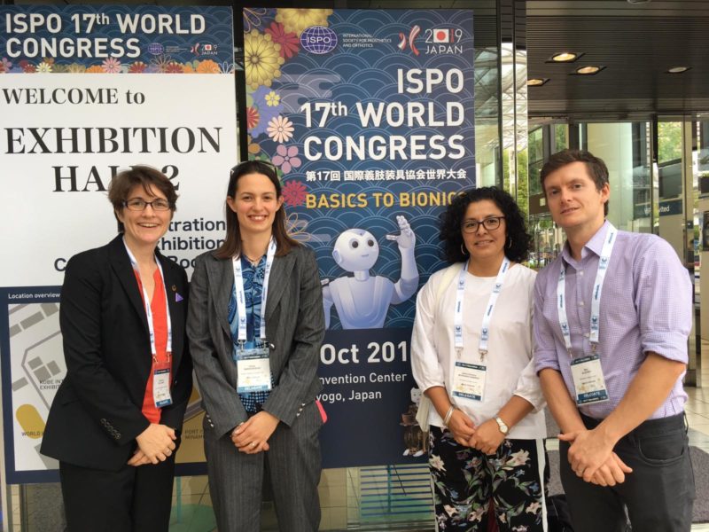 Cathy, Ben, Giulia and Dafne smiling next to an ISPO poster Cover Image