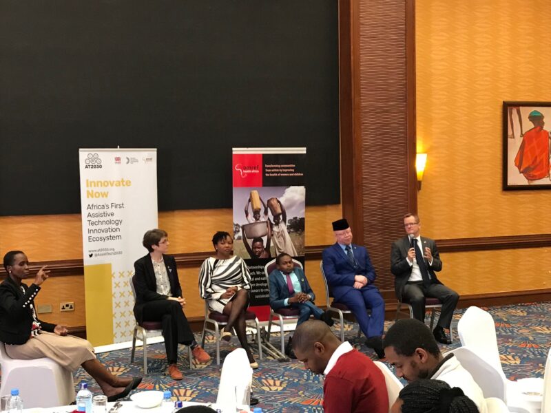 Panel sitting down while presenting during an event Cover Image