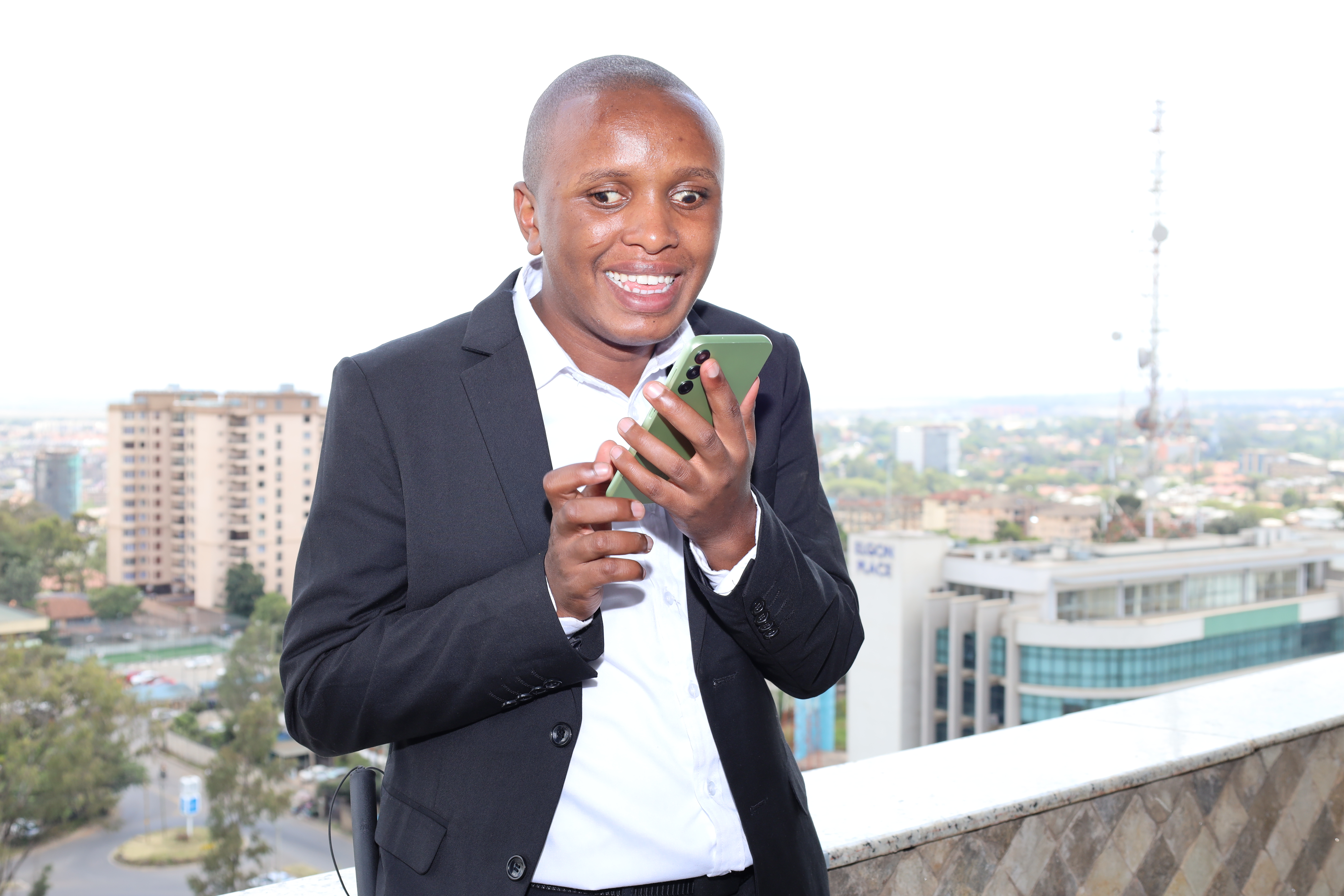 John Mwangi using a mobile phone Cover Image