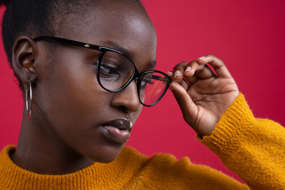 Image of glasses being worn by a young African women in photoshoot Cover Image