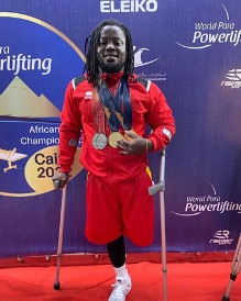 Emmanuel Nii Tettey Oku with his medals at the World Para Powerlifting event in Cairo, 2022. Cover Image
