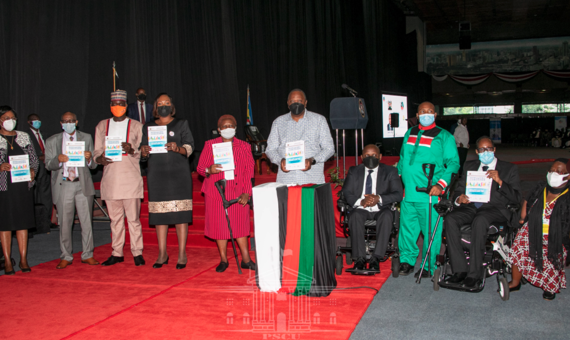 The President standing alongside other attendees for a photo opportunity Cover Image