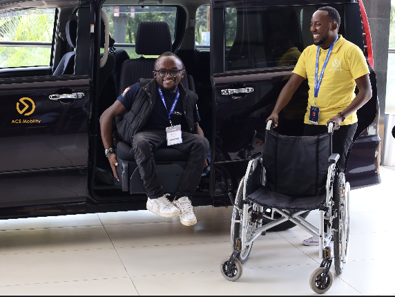 Danoiel Kamau demonstrating how the swivel chair works in his car Cover Image