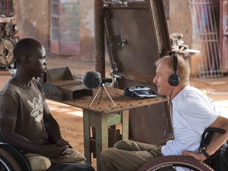 David sitting in a wheelchair speaking to another man in a wheelchair Cover Image