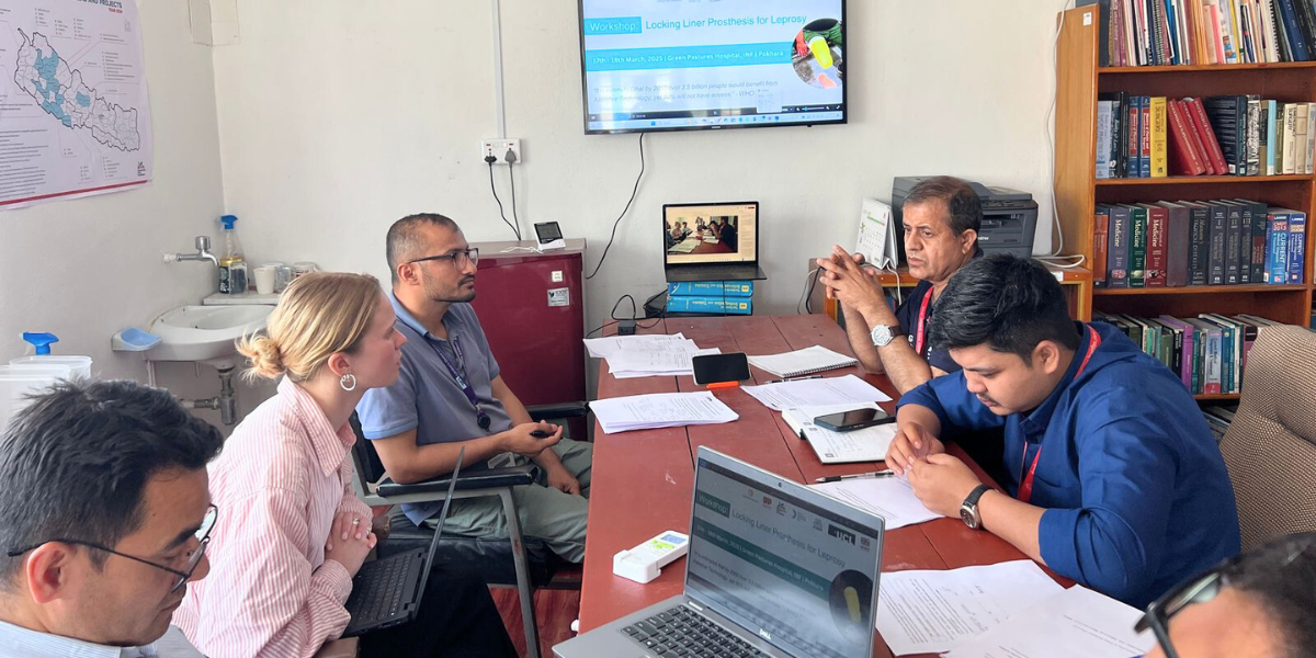 Conditions and the project team are sat around a table in discussion 