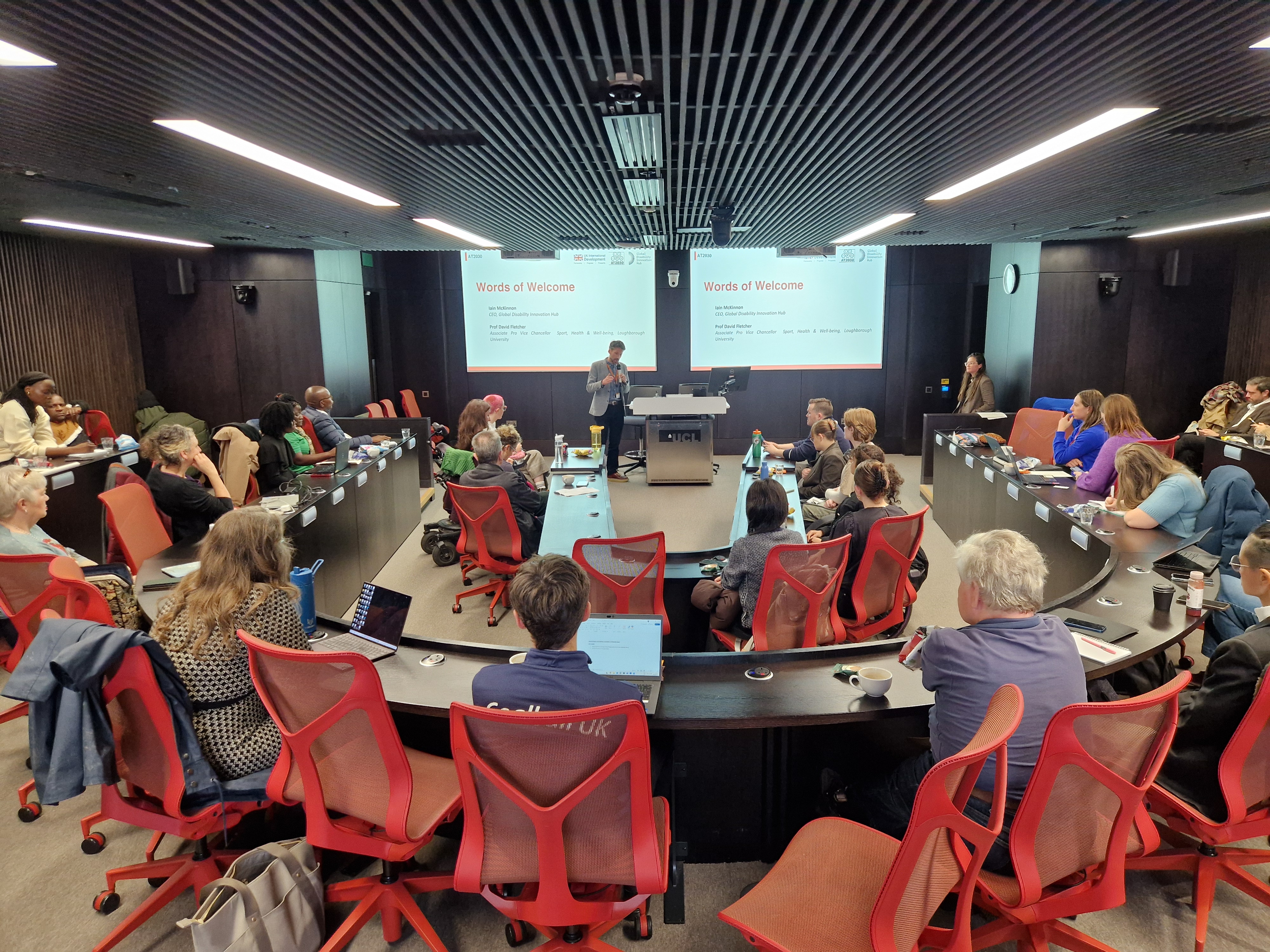 Image of lecture theatre full of people listening to opening remarks at the event
