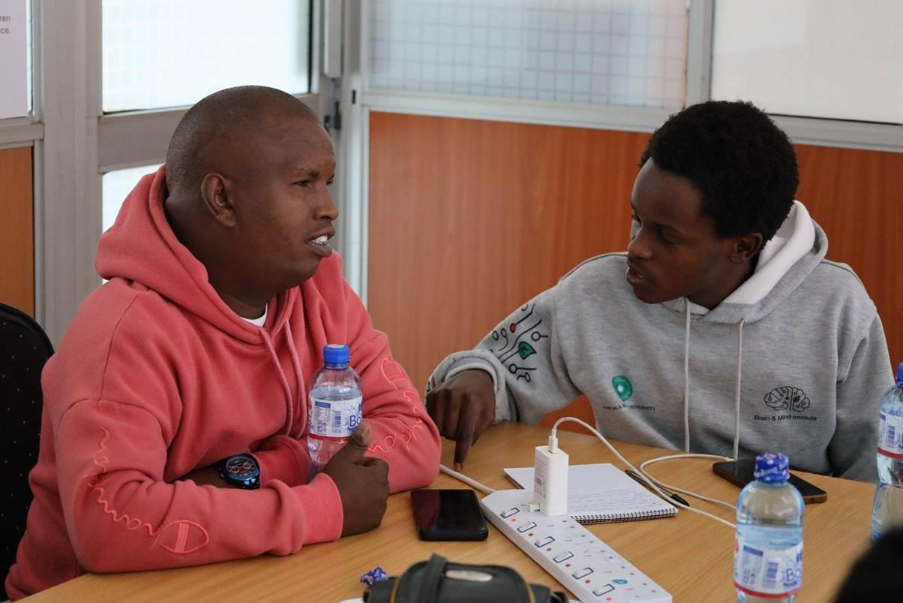 Two people in discussion around a table.