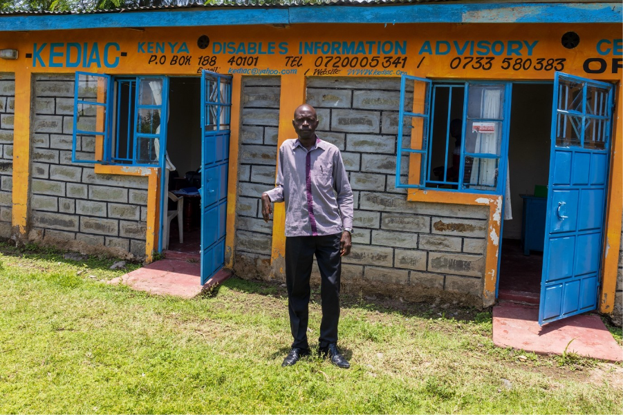 Paul Olang outside his office