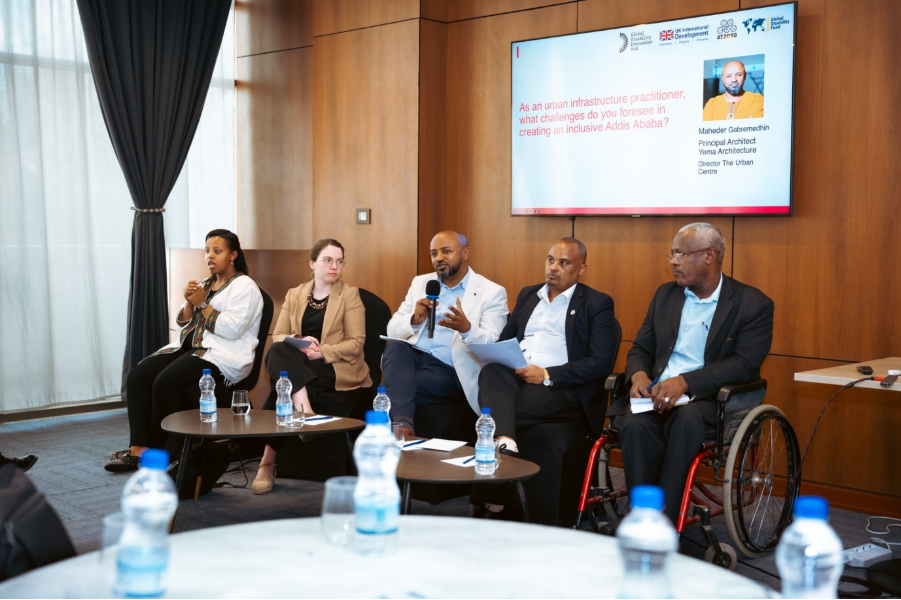 From left to right, panellist visible include: sign language interpreter; Mikaela Patrick, Head of Research & Delivery, GDI Hub; Maheder Gabremedhin, Director, The Urban Centre (speaking); Sisay Tilahun, CEO, Disability Affairs, Ministry of Women and Social Affairs; and Yosef Fekadu, Executive Director, Inclusive Ethiopia. On screen a question reads: ‘as an urban infrastructure practitioner, what challenges do you foresee in creating and inclusive Addis Ababa’.