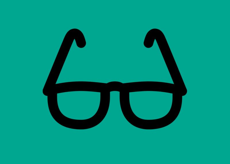 A photo of glasses on a green background