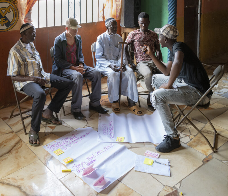 Amadu leads a group with partially sighted participants. Image Credit: Angus Stewart. Photo taken as part of the AT2030 programme work in Sierra Leone.