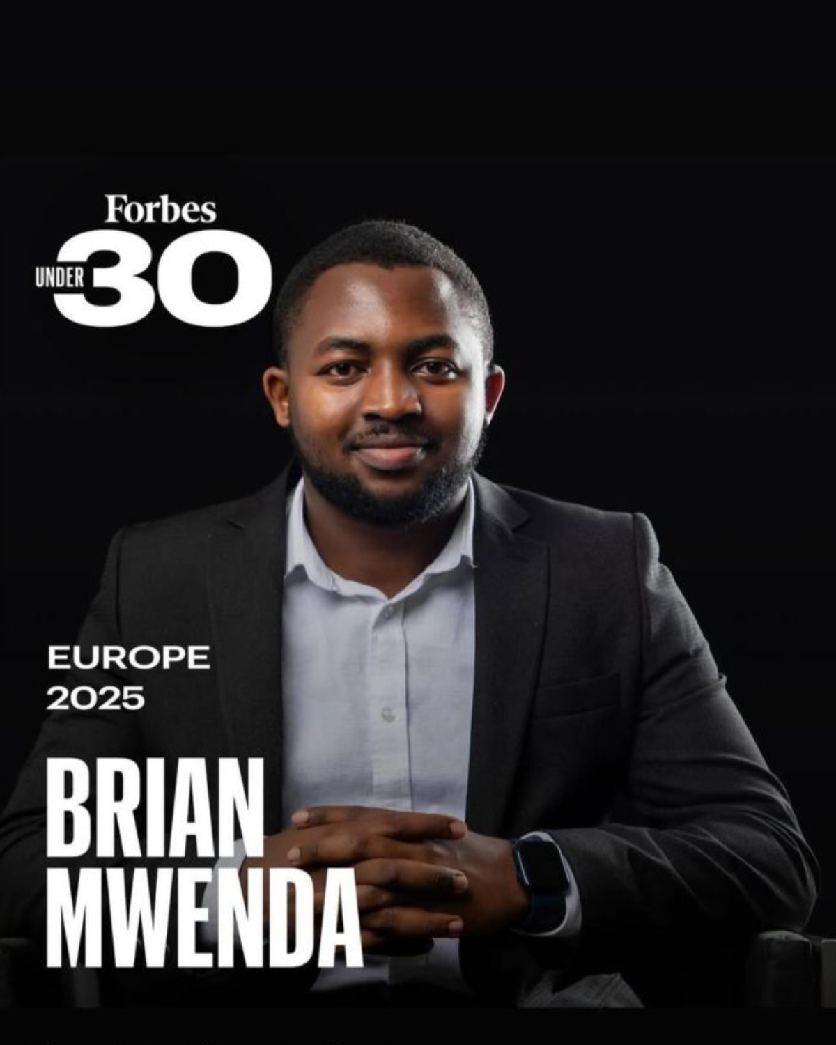 Portrait of Brian Mwenda seated confidently against a black background. He is wearing a dark suit jacket, white shirt, and a smartwatch. The text reads “Forbes Under 30, Europe 2025, Brian Mwenda” Cover Image