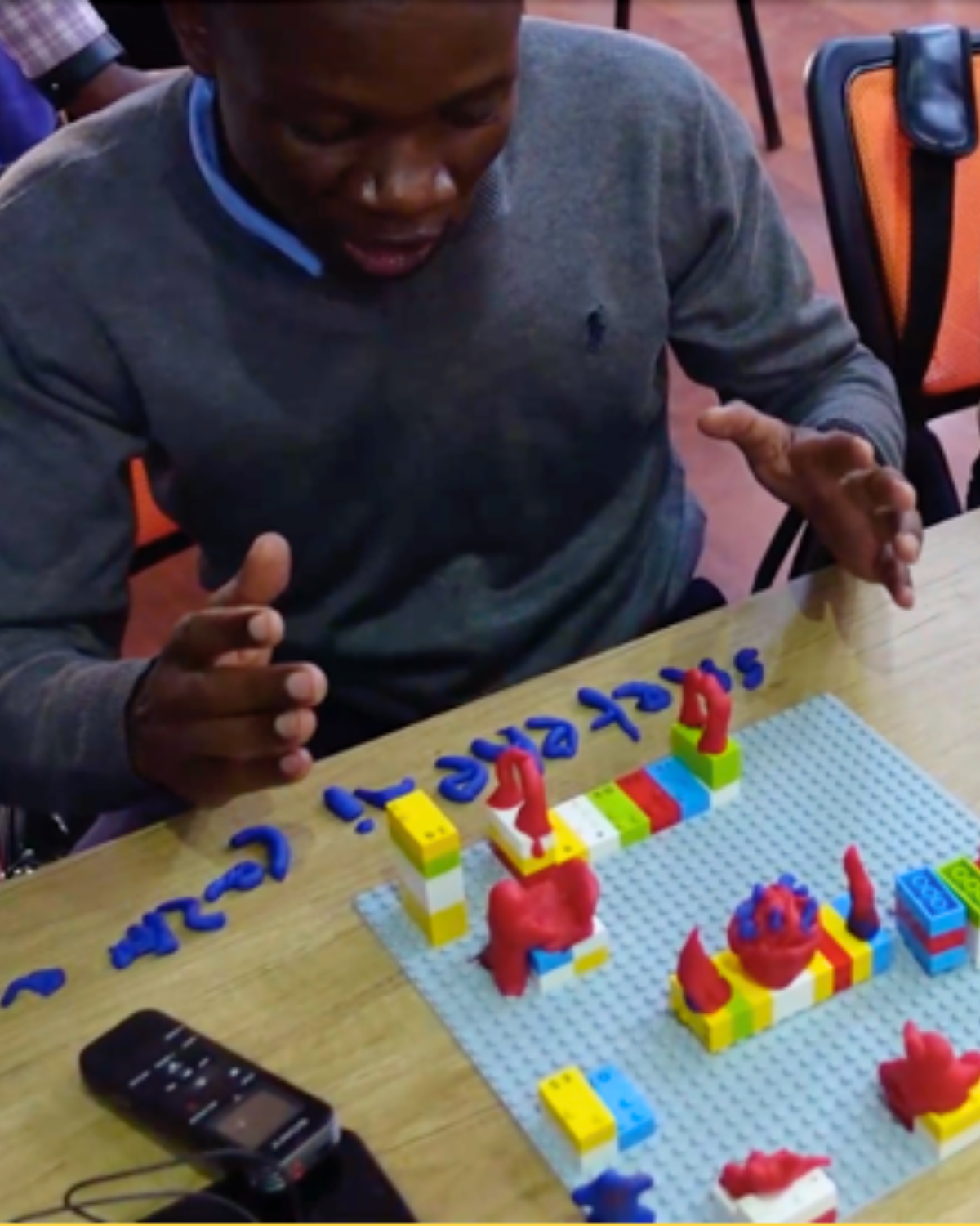 A group of people building with lego in a storytelling workshop Cover Image
