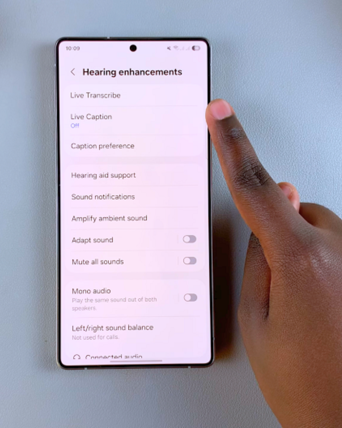 Hand on Phone's settings, setting up closed captioning Cover Image