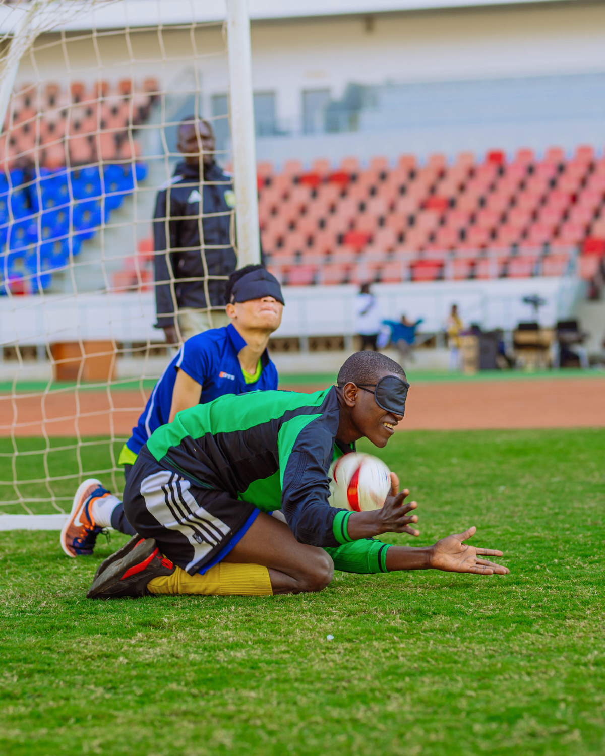 two people playing football with blindfolds on while on their knees Cover Image