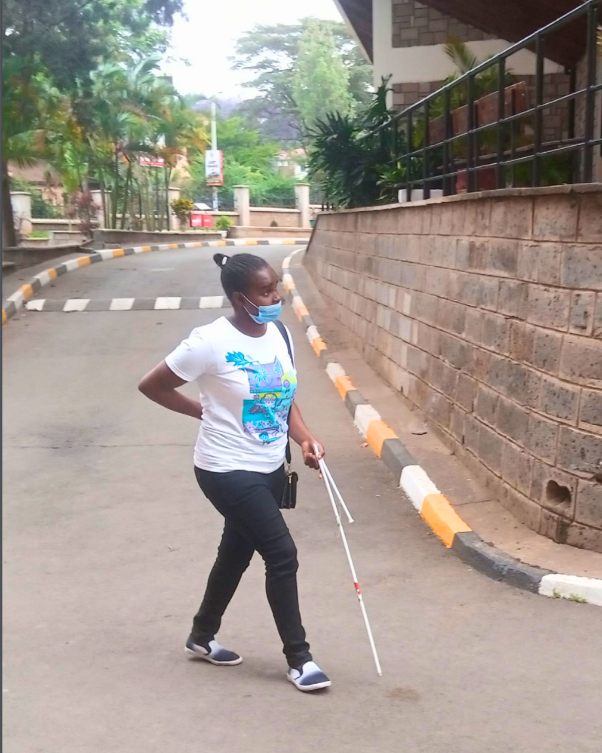 Person walking with a white stick on road Cover Image