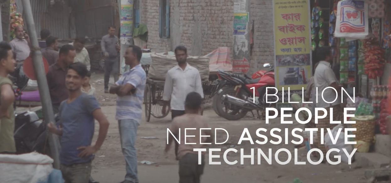 The background shows a market scene with overlay text "1 billion people need assistive technologies" Cover Image