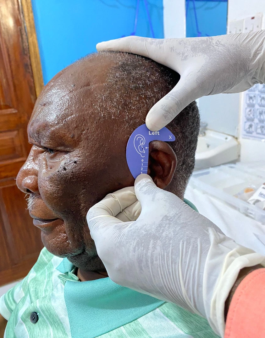 Man being fitting with a hearing aid Cover Image